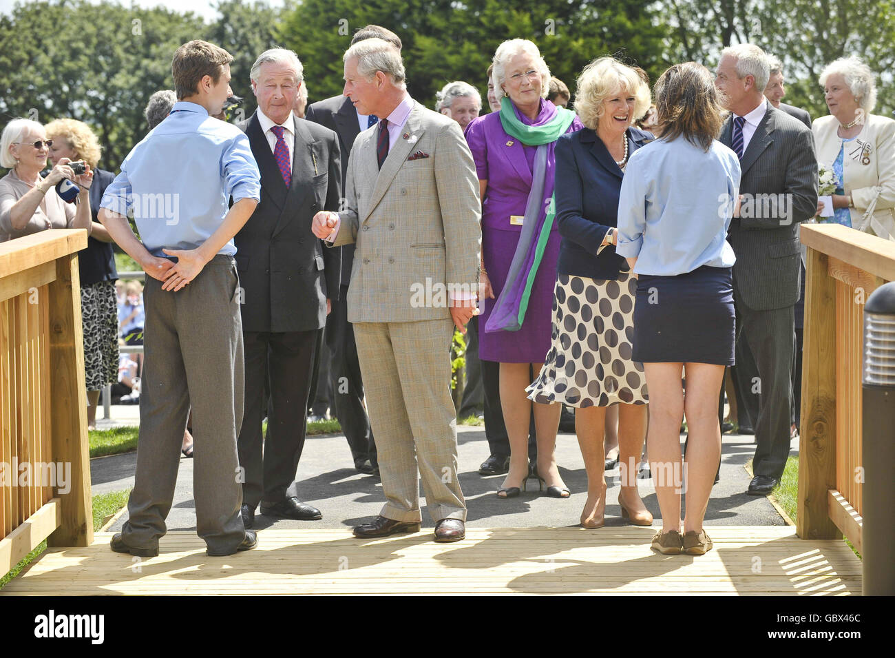 The Prince of Wales and the Duchess of Cornwall chat to pupils before entering into the Integrated Health Centre during their visit to Penair School, Truro, Cornwall. Stock Photo