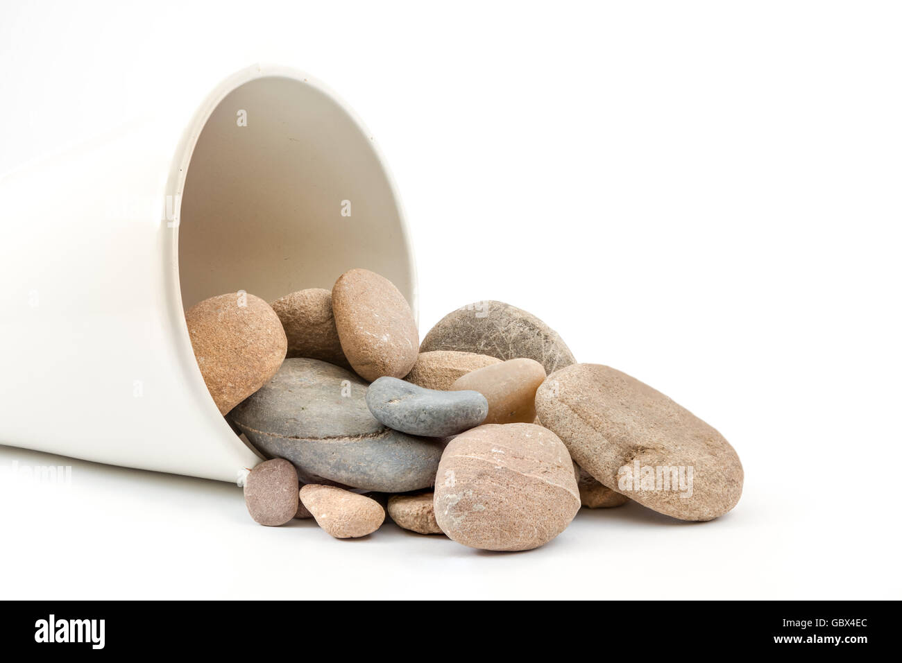 on the ground there is a vase where there are boulders fallen from Stock Photo
