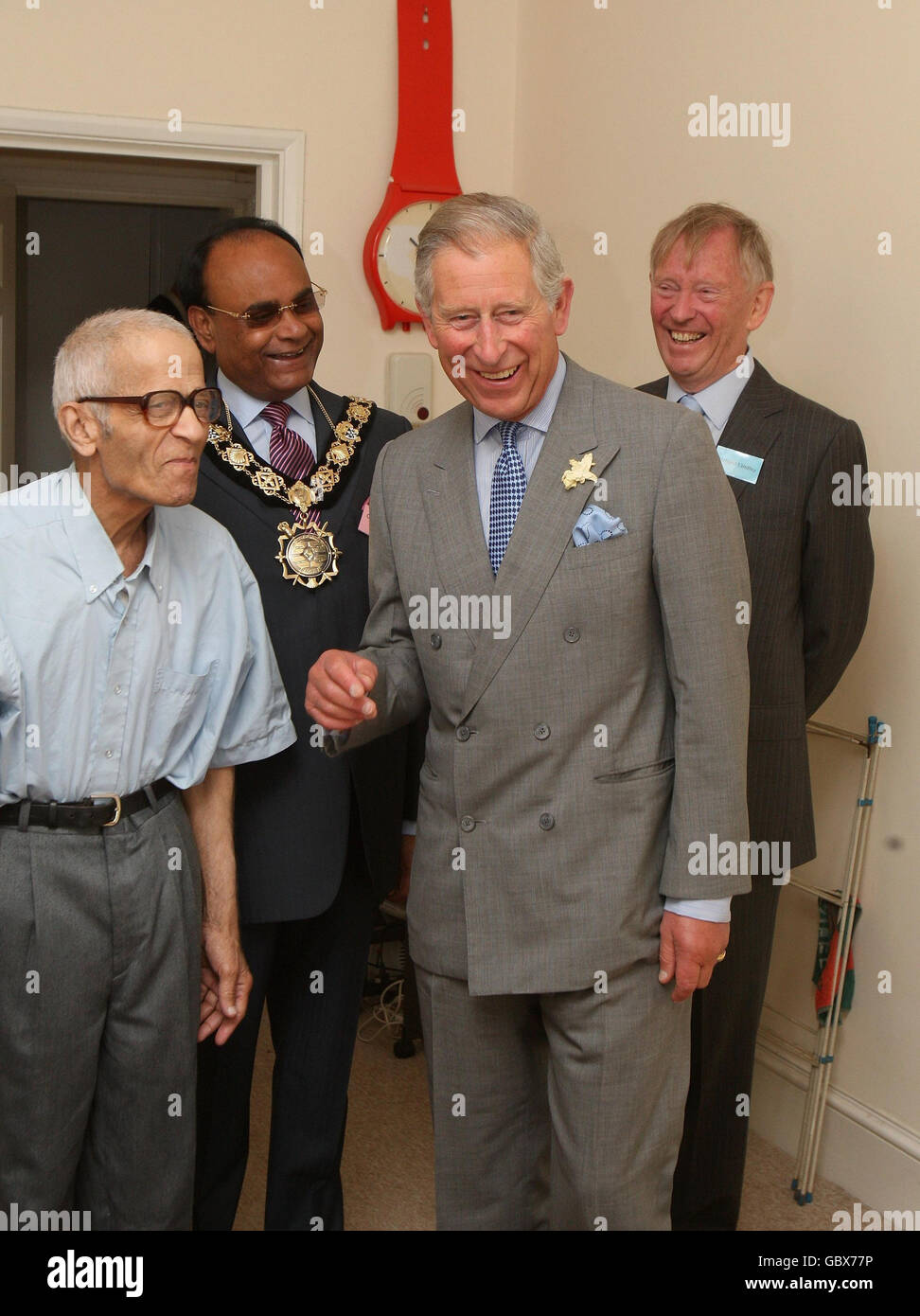 The Prince of Wales, right, patron of the Almshouse Association, meets resident Yusuf Kurtha, left, during a visit to St Pancras almshouses in north London to celebrate the 150th anniversary of the Almshouses. Stock Photo