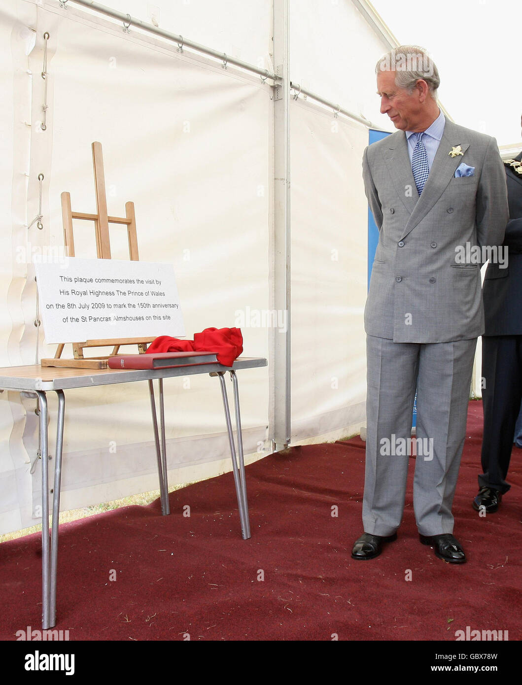 The Prince of Wales, patron of the Almshouse Association, unveils a plaque, during a visit to St Pancras almshouses in north London to celebrate the 150th anniversary of the Almshouses. Stock Photo