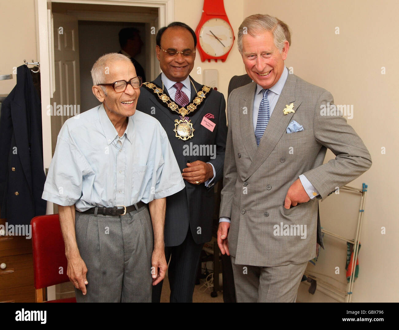 The Prince of Wales, right, patron of the Almshouse Association, meets resident Yusuf Kurtha, left, during a visit to St Pancras almshouses in north London to celebrate the 150th anniversary of the Almshouses. Stock Photo