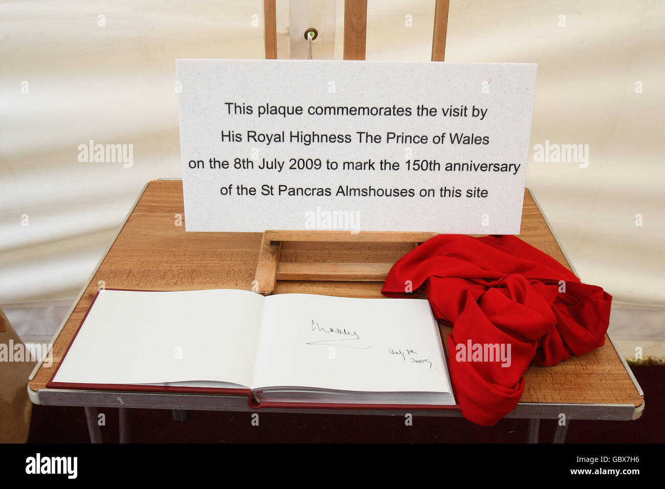 A Plaque unveiled by the Prince of Wales, patron of the Almshouse Association, next to the visitors book, during a visit he made to St Pancras almshouses in north London to celebrate the 150th anniversary of the Almshouses. Stock Photo
