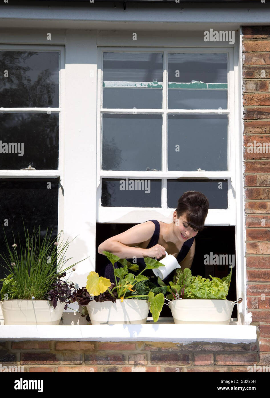 Chef and food writer Gizzi Erskine, at her home in east London for the launch of the National Trust's 'Window Food' campaign to turn 600 acres of urban window ledges into vertical vegetable gardens. Stock Photo