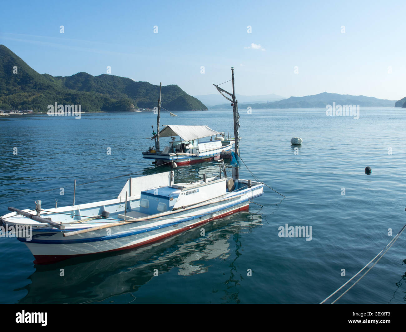 Two wooden fishing boats moored in the Seto Inland Sea. Stock Photo