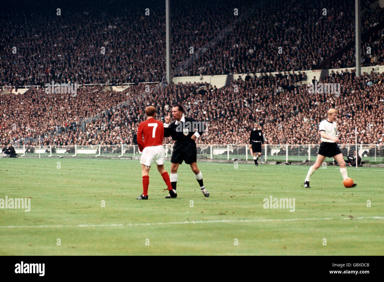 Referee Gottfried Dienst (second l) gives England's Alan Ball (l) a ticking off as West Germany's Karl-Heinz Schnellinger (r) retrieves the ball, watched by linesman Tofik Bakhramov (second r) Stock Photo