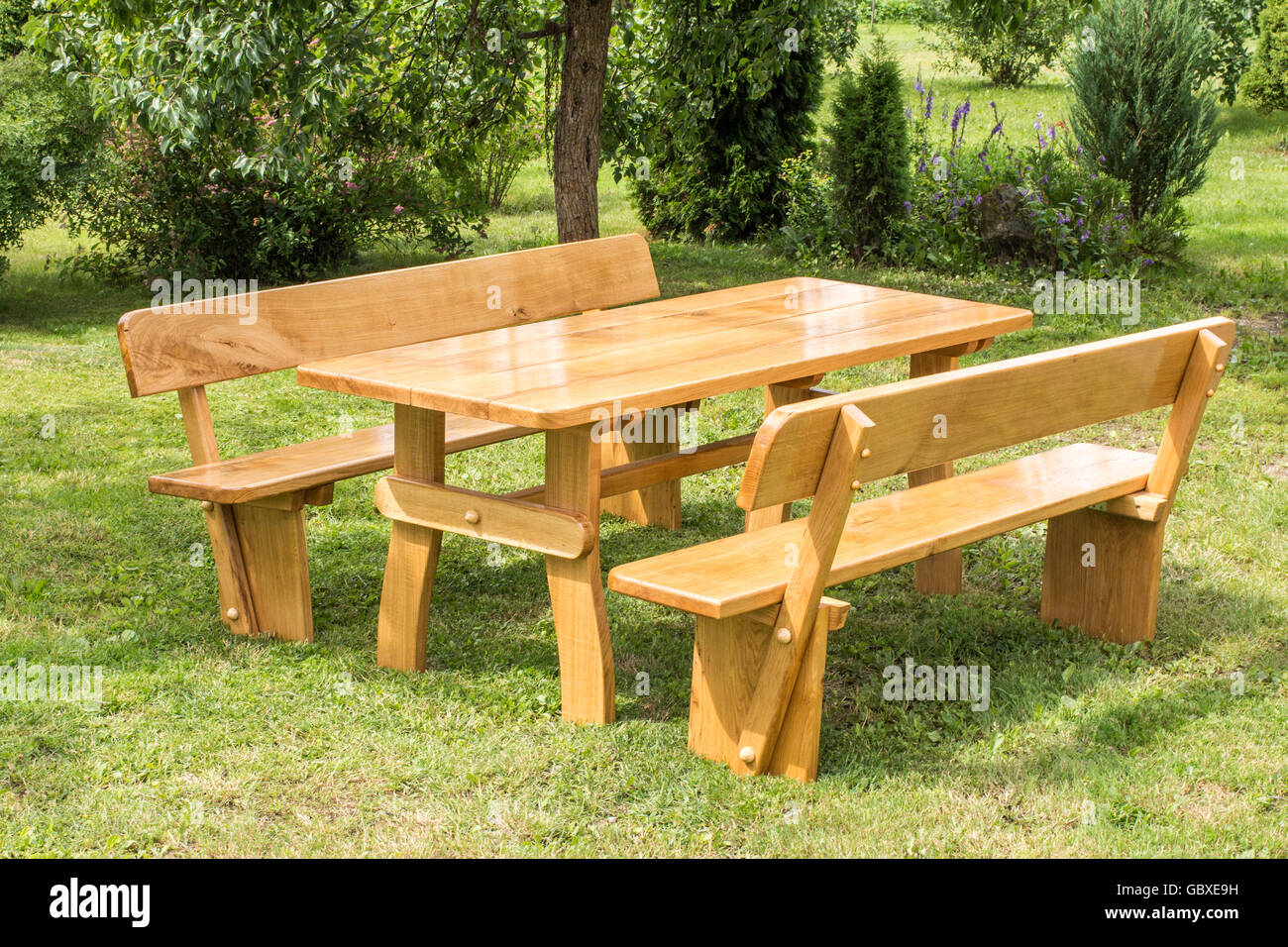 Wooden Set Of Table Benches With Backrests On Green Grass Lawn