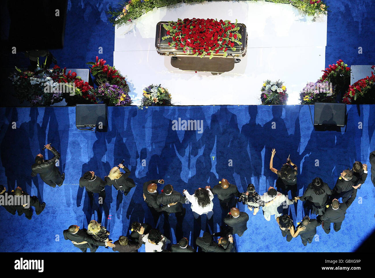 Family and friends sing 'We are the World' during at a memorial service for Michael Jackson at the Staples Center in Los Angeles. Stock Photo