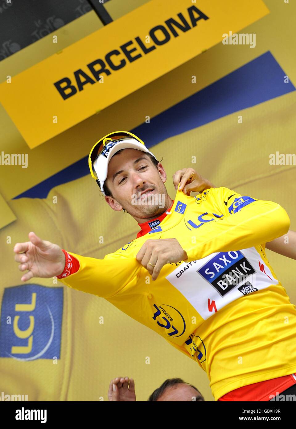 Team Saxo Bank's Fabian Cancellara wearing the yellow jersey on the podium  after the sixth stage of the Tour de France between Gerone and Barcelona  Stock Photo - Alamy