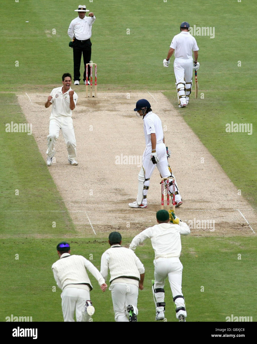 Australia's Michell Johnson (left) celebrates taking the wicket of England's Alastair Cook as he shows his dejection during day Four of the first npower Test match at Sophia Gardens, Cardiff. Stock Photo