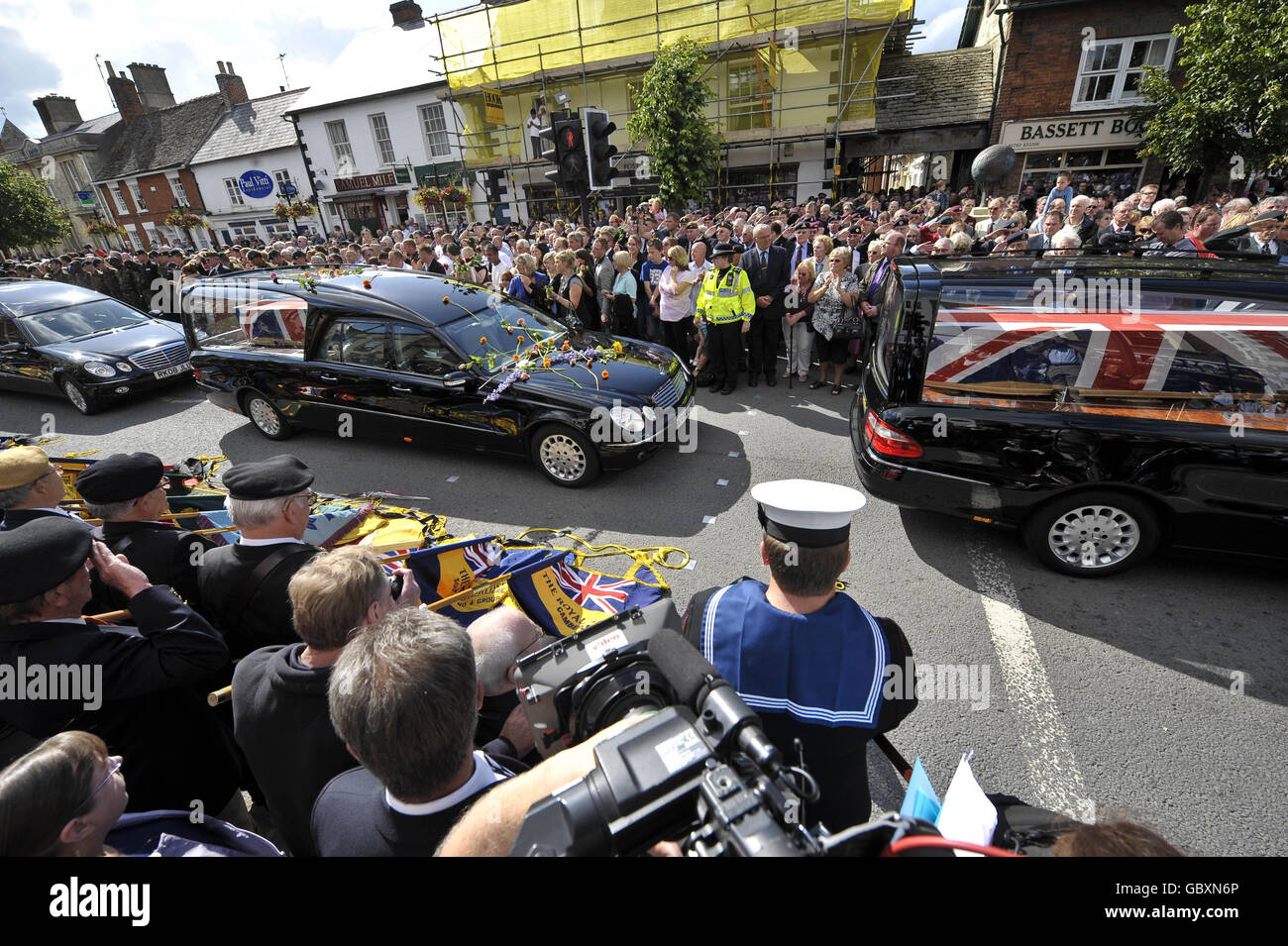 Eight hearses carrying the bodies of eight British soldiers killed during the Army's bloodiest 24 hours in Afghanistan, make their way through the Wiltshire village of Wootton Bassett. Stock Photo