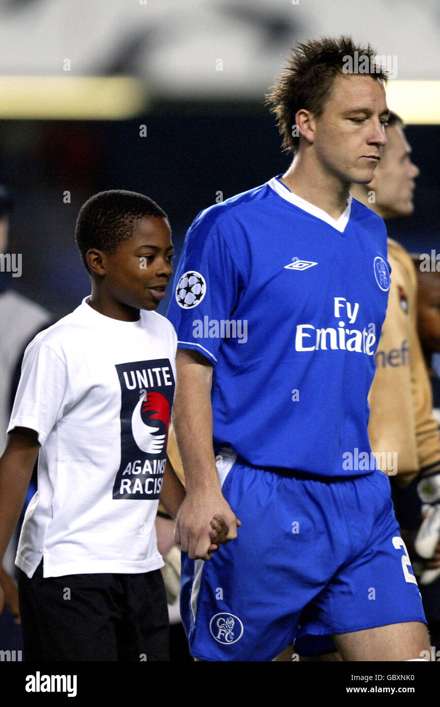 Soccer - UEFA Champions League - Group H - Chelsea v CSKA Moscow. Chelsea's captain John Terry leads out a mascot wearing a Unite against racism t-shirt Stock Photo