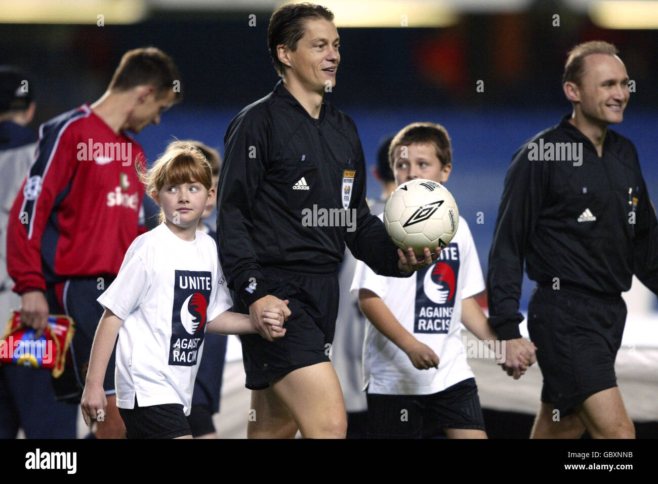 Soccer - UEFA Champions League - Group H - Chelsea v CSKA Moscow. Referee Lubos Michel leads out mascots wearing Unite against racism t-shirts Stock Photo