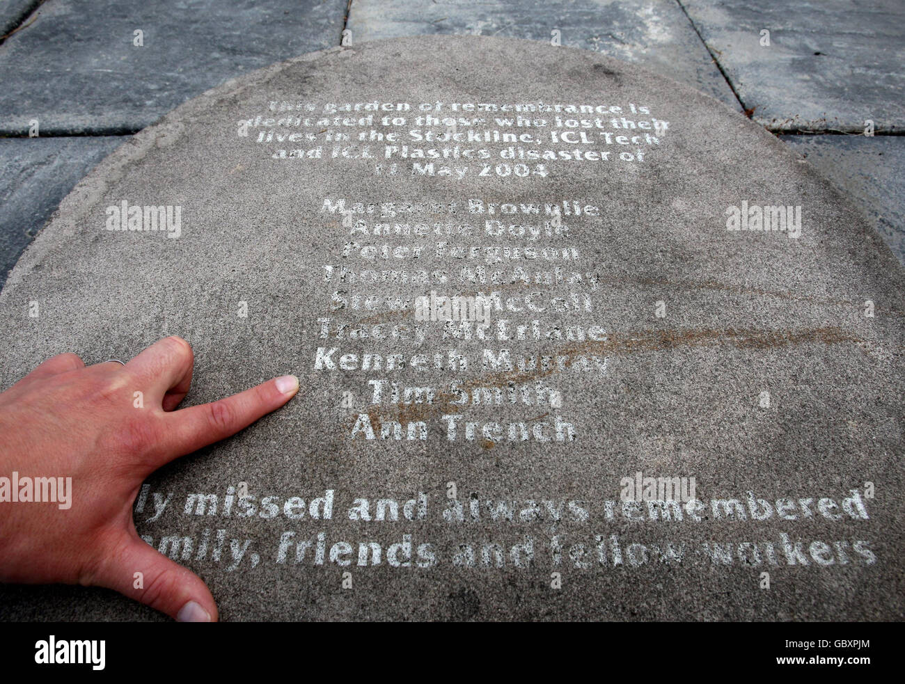 A stone with the names of the dead from the Stockline factory tragedy etched into it, in the memorial garden at the former site of the disaster which killed nine people and injuring 33. Stock Photo