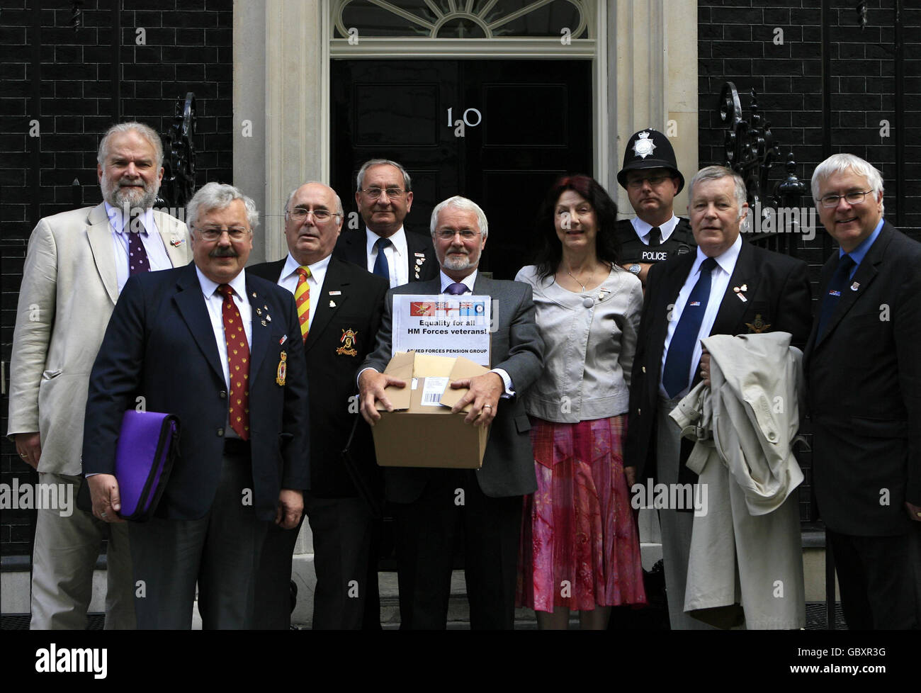 Members and supporters of the Armed Forces Pension Group (AFPG) hand in a petition, signed by almost 200,000 people demanding pension rights for ex-servicemen and women, to 10 Downing Street in central London, (left to right) the Labour MP for Morley and Rothwell Colin Challen, Brian Allinson, Sid West, Mike Steel, David Nebard, June Cavender, Richard Putnam and the Liberal Democrat MP for Colchester Bob Russell. Stock Photo