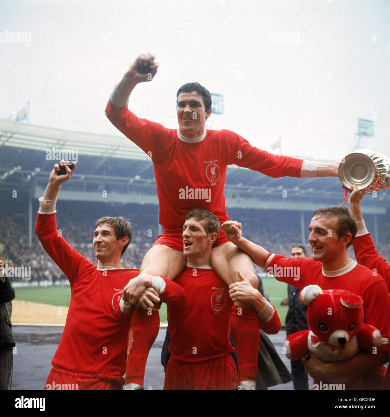 Liverpool's Ron Yeats (top) is hoisted aloft by teammates (l-r) Geoff Strong, Wilf Stevenson and Peter Thompson as they celebrate victory Stock Photo