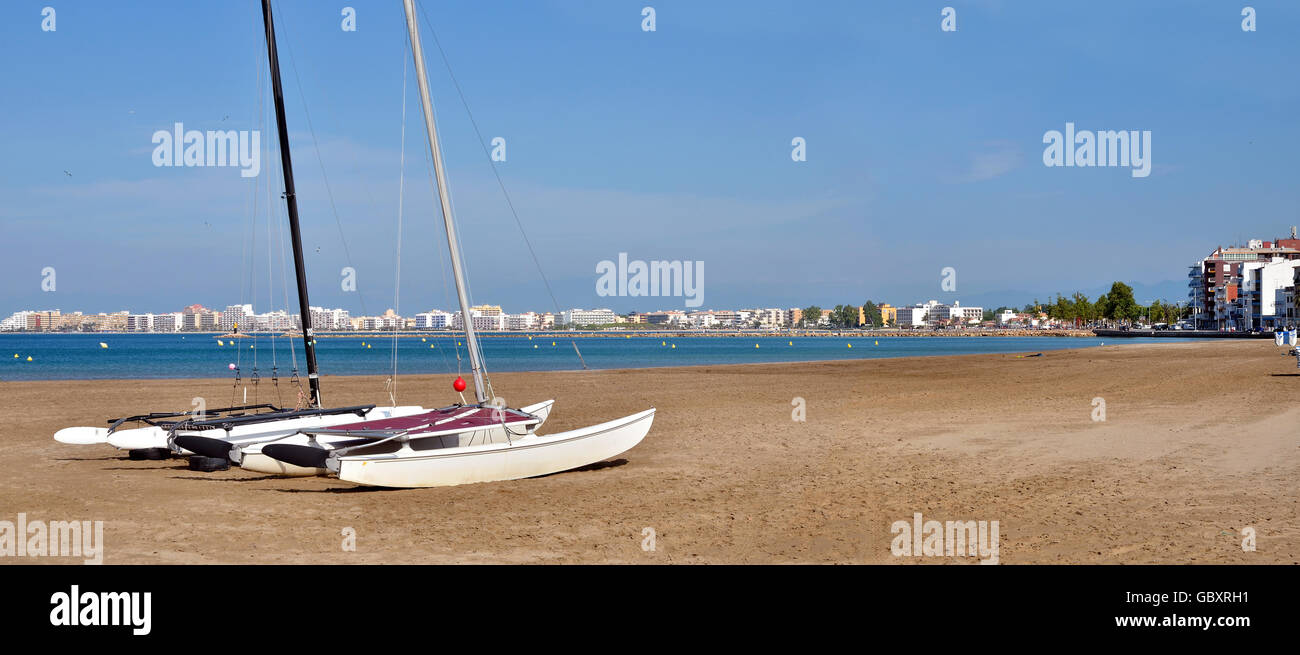 Panoramic photo of catamarans on the beach of Roses, or Rosas, commune on the Costa Brava at northeastern Catalonia in Spain Stock Photo