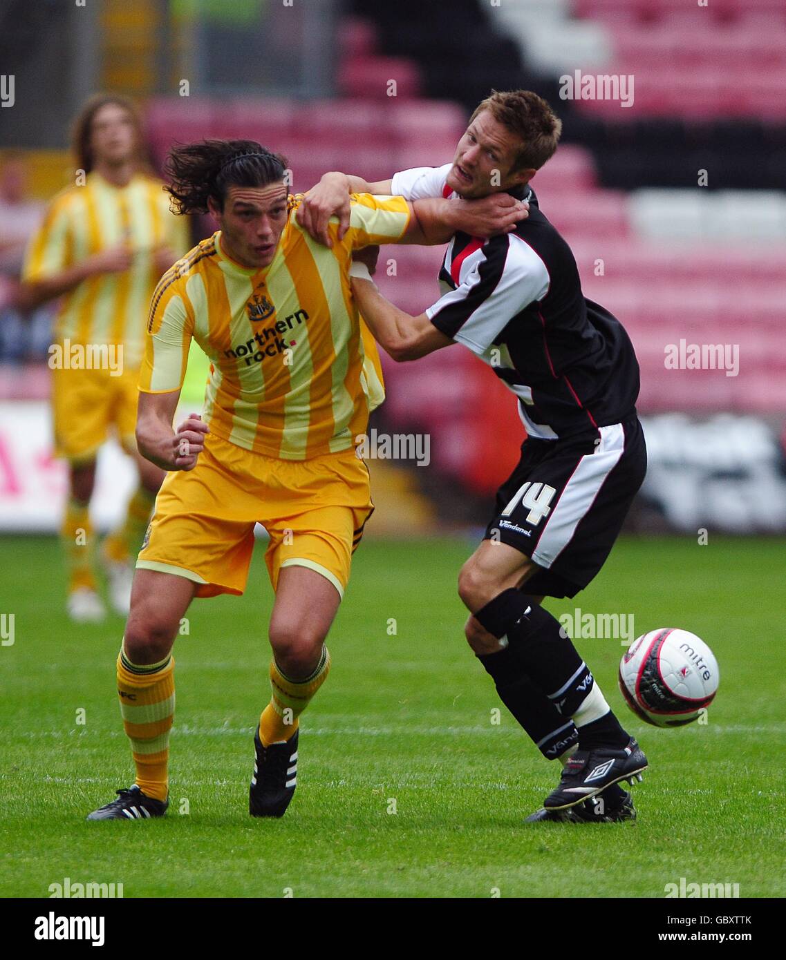 Newcastle United's Andrew Carroll (left) and Darlington's Ian Miller (right) battle for the ball. Stock Photo