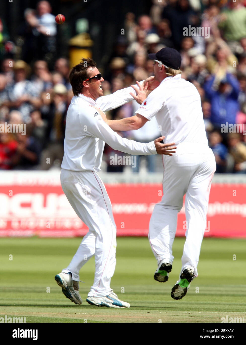 England's Graeme Swann (left) celebrates taking the wicket of Australia's Michael Hussey with teammate Paul Collingwood during the fourth day of the second npower Test match at Lord's, London. Stock Photo