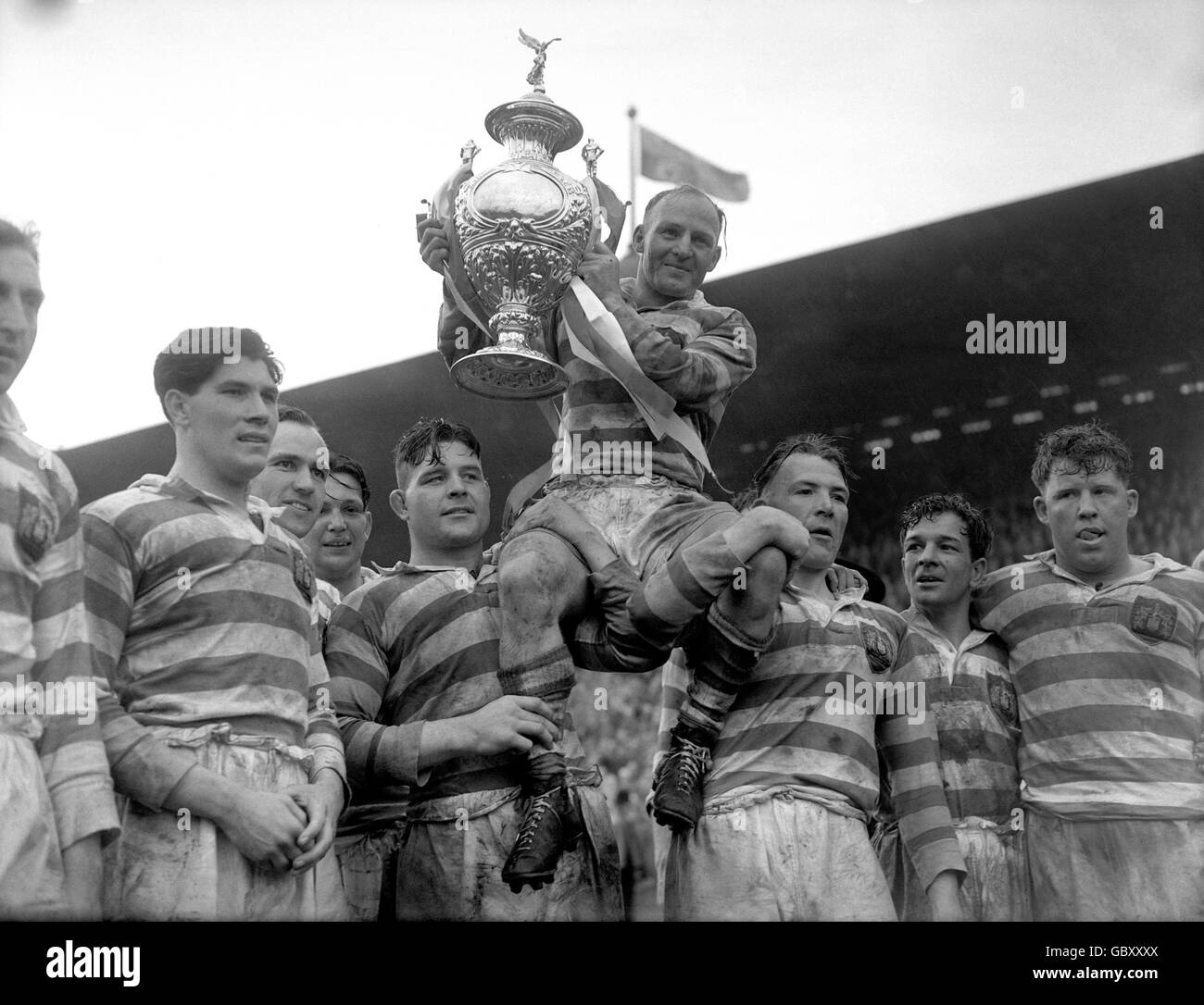 Cecil Mountford, Wigan rugby captain, is chaired by his team mates as he holds the Rugby League Cup at Wembley Stadium. Wigan beat Barrow 10-0. Stock Photo