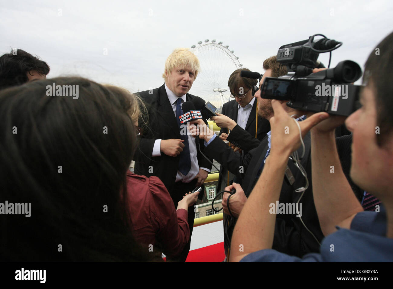 The Mayor of London Boris Johnson is interviewed by the media as he attends a topping out ceremony on the 13th floor of the Park Plaza Westminster Bridge Hotel on the south-side of Westminster Bridge in London. Stock Photo