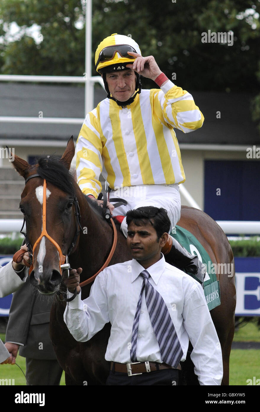 Monsieur Chevalier and Richard Hughes return to the winners enclosure after victory in The Weatherbys Super Sprint during Weatherbys Super Sprint Day at Newbury Racecourse, Berkshire. Stock Photo