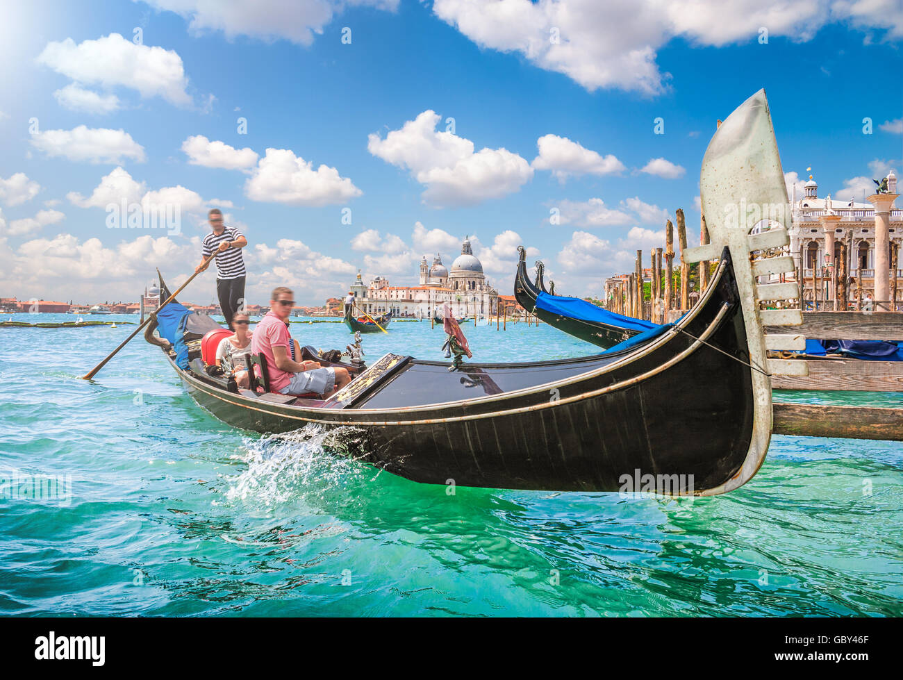 Traditional Gondola on Canal Grande with historic Basilica di Santa Maria della Salute in the background, Venice, Italy Stock Photo