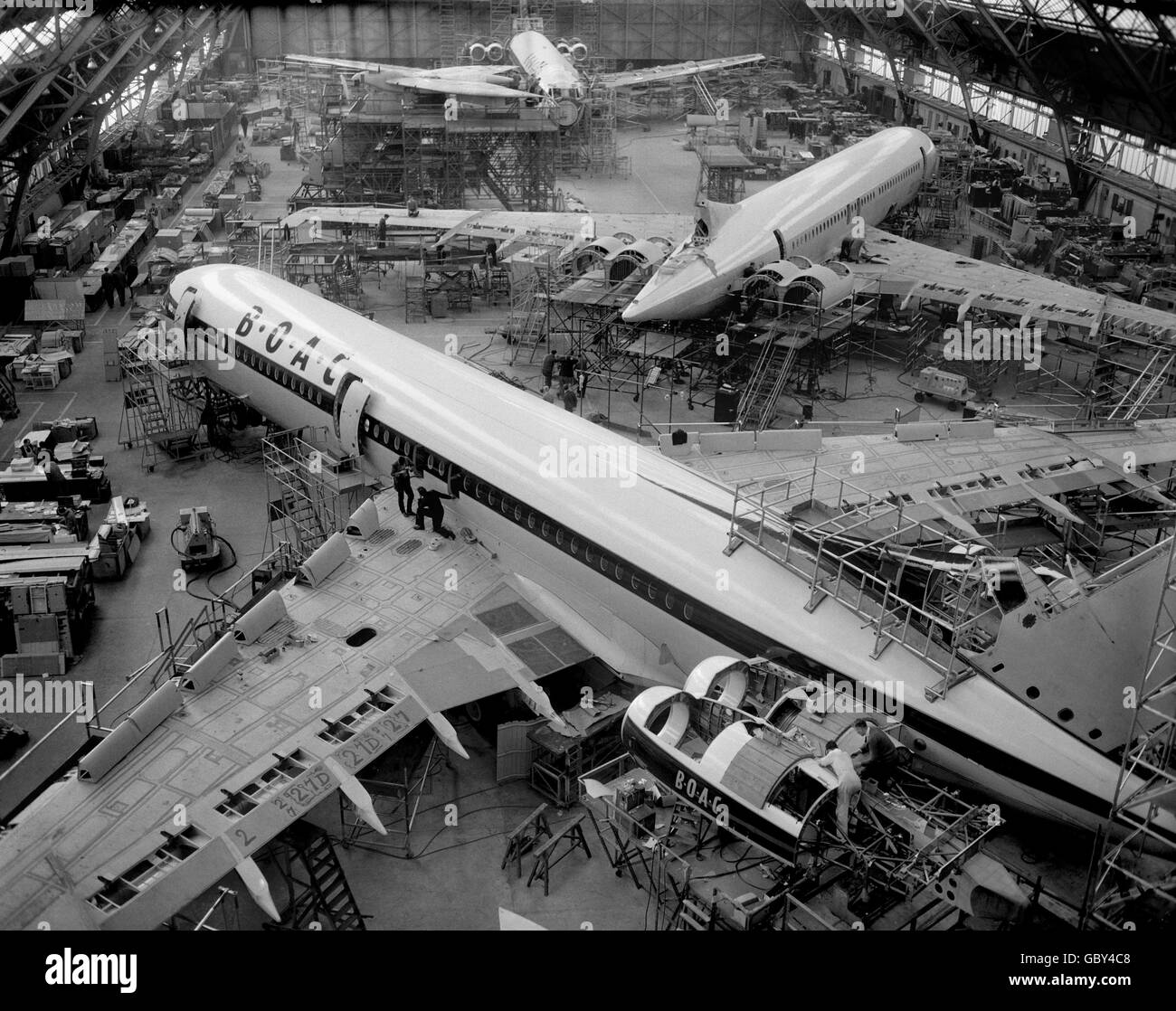 Work on the British Aircraft Corporation's huge new Vickers VC10 airliners, in a vast assembly hall of the Vickers factory at Brooklands, Weybridge, where several aircraft are nearing completion. Stock Photo