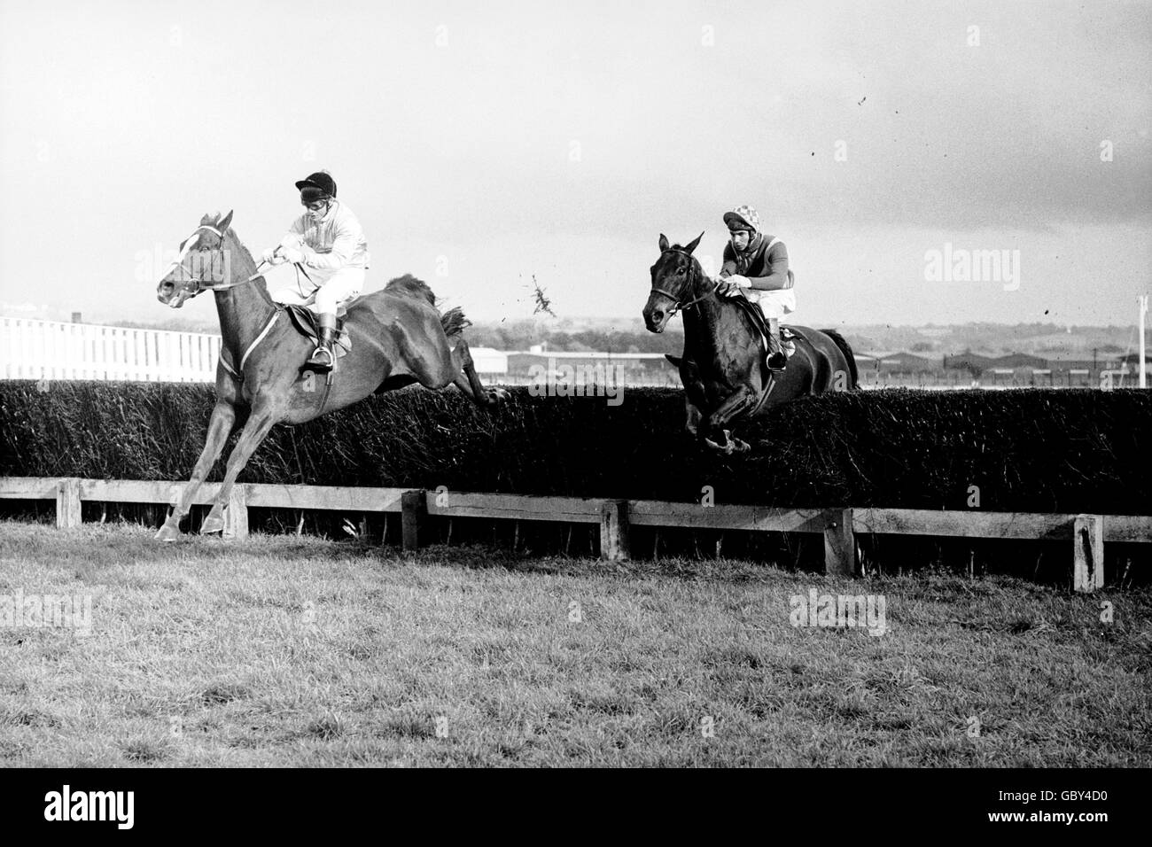 (L-R) Eventual winner Game Spirit, Bill Smith up, clears the fourth fence ahead of Bula, John Francome up Stock Photo