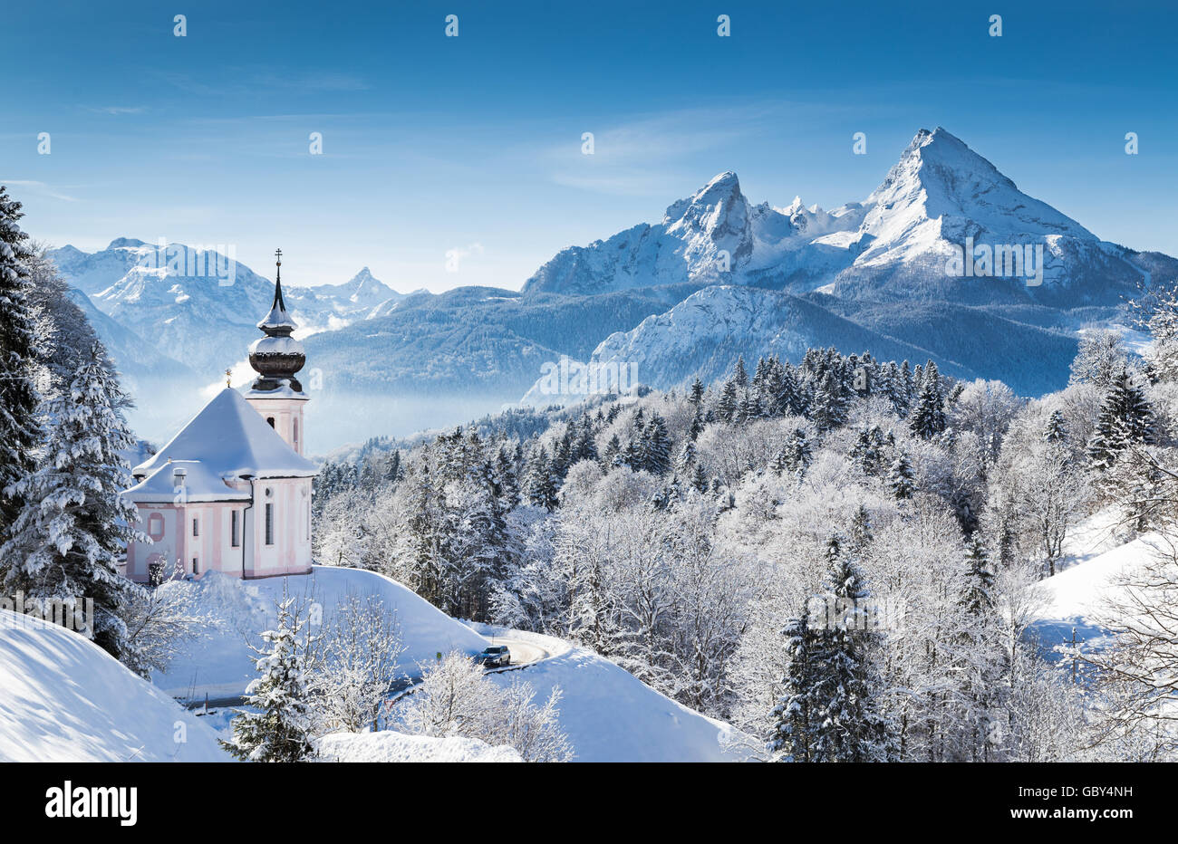 Idyllic winter wonderland in the Alps with pilgrimage church of Maria Gern and famous Watzmann mountain summit, Bavaria, Germany Stock Photo