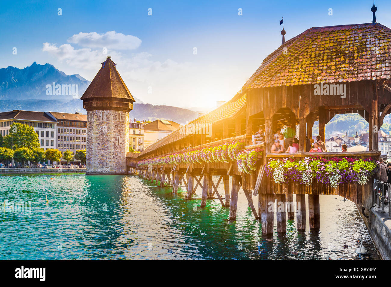 Historic city center of Lucerne with famous Chapel Bridge and Mount Pilatus at sunset, Switzerland Stock Photo