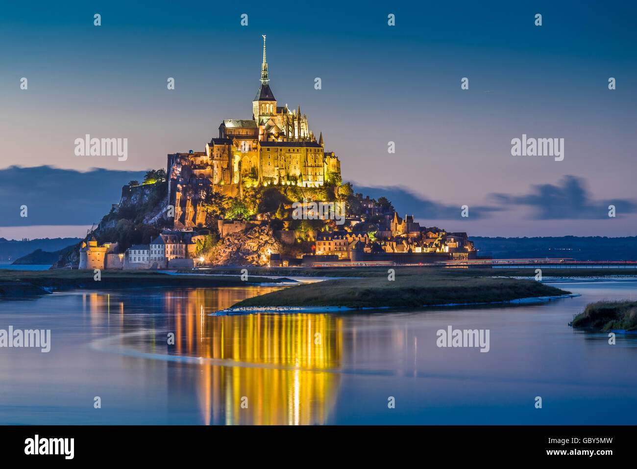 Classic view of famous Le Mont Saint-Michel tidal island in beautiful twilight during blue hour at dusk, Normandy, France Stock Photo