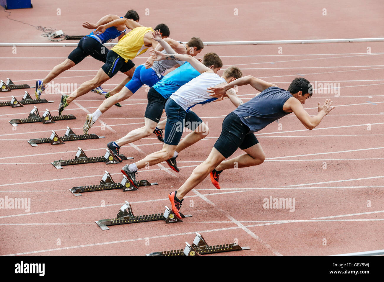 men sprinters start at 100 meters during Ural championship in athletics Stock Photo