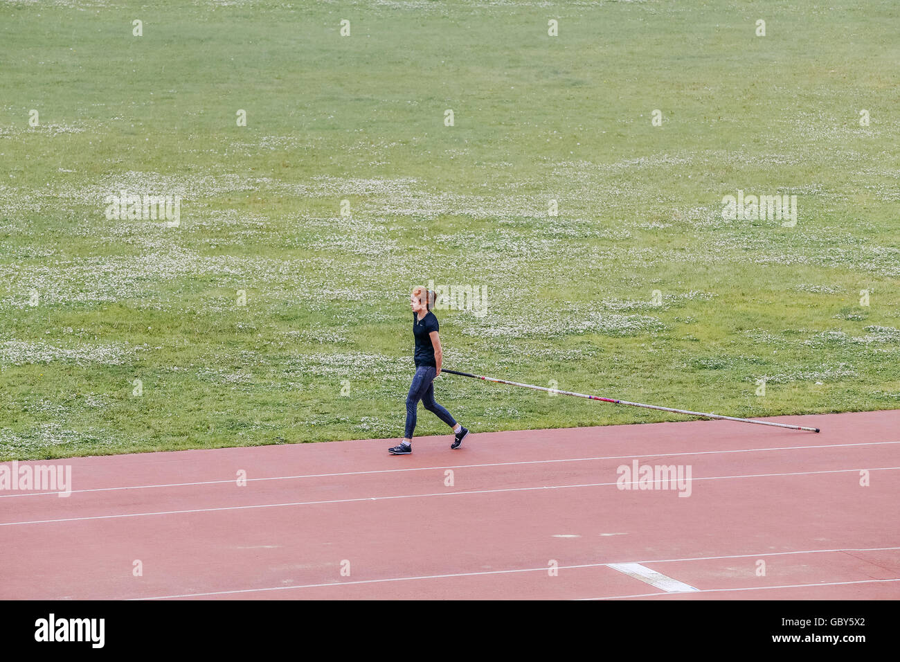 girl is preparing for pole vault in stadium during Ural championship in athletics Stock Photo