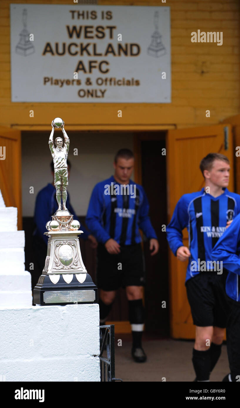 The Sir Thomas Lipton Trophy watches over players taking to the pitch for their match against Stokesley at the Darlington Road Ground, West Auckland. Stock Photo