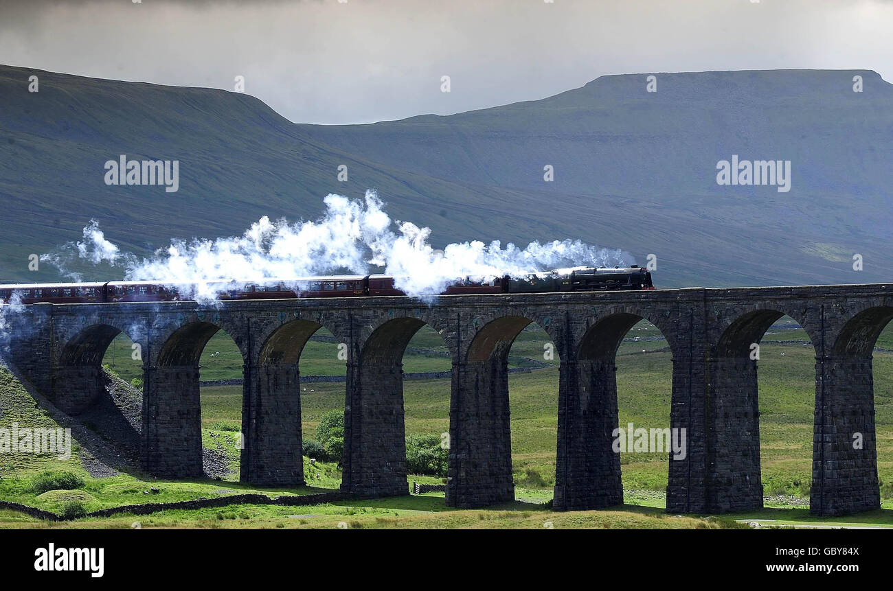The Cumbrian Mountain Express pulled by the Scots Guardsman locomotive makes its first trip of the Summer between York and Carlisle crossing the Ribblehead Viaduct. Stock Photo