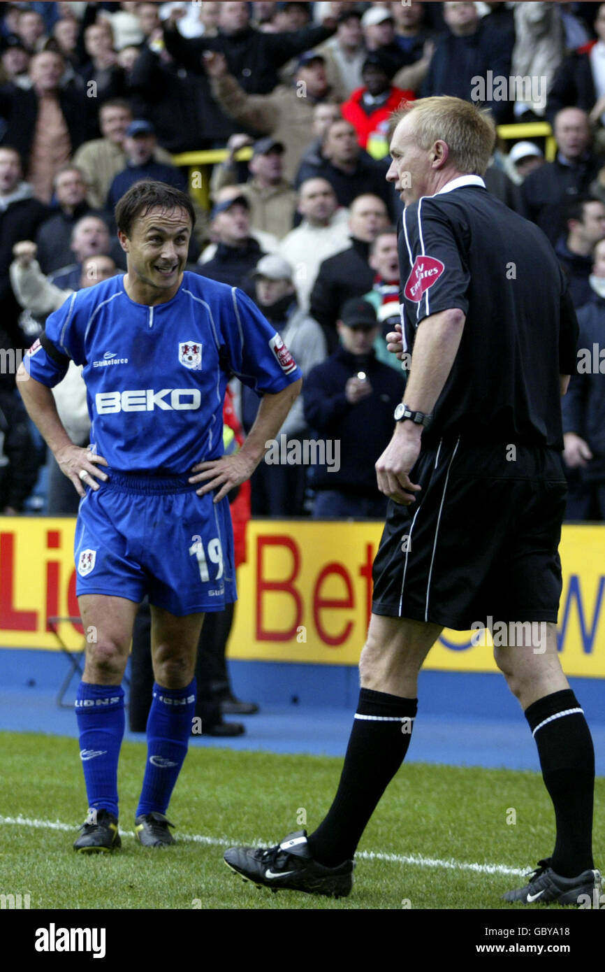 Soccer - Coca-Cola Football League Championship - Millwall v West Ham United. Millwall's Dennis Wise sees the funny side as he struggles to take a corner after West Ham United fans threw coins at him Stock Photo