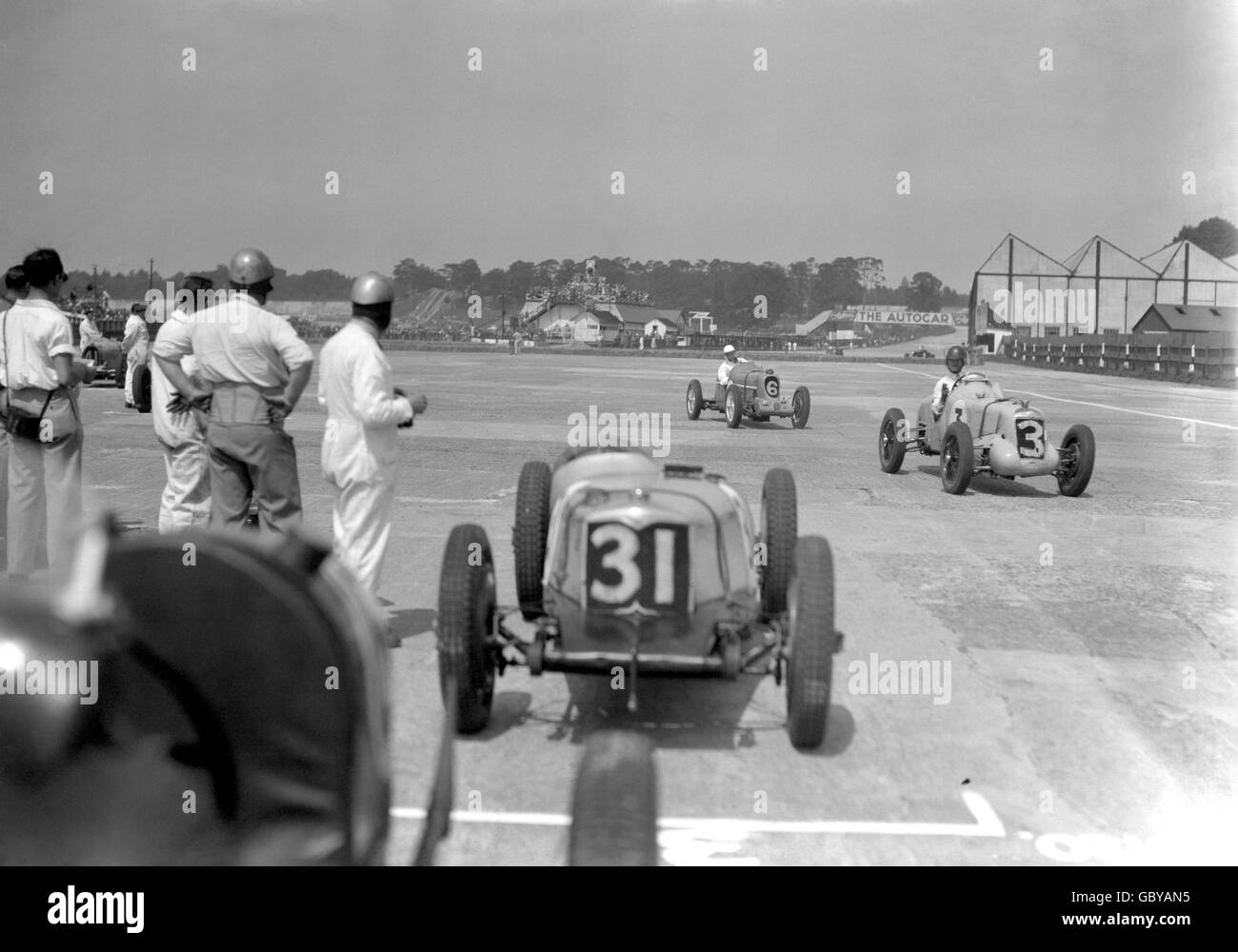 Motor Racing - British Empire Race - Brooklands. Freddie Dixon, (31) Riley, watching Norman Black, (3) MG, and Dennis Evans (6) MG, pass by during the British Empire Race at Brooklands. Stock Photo