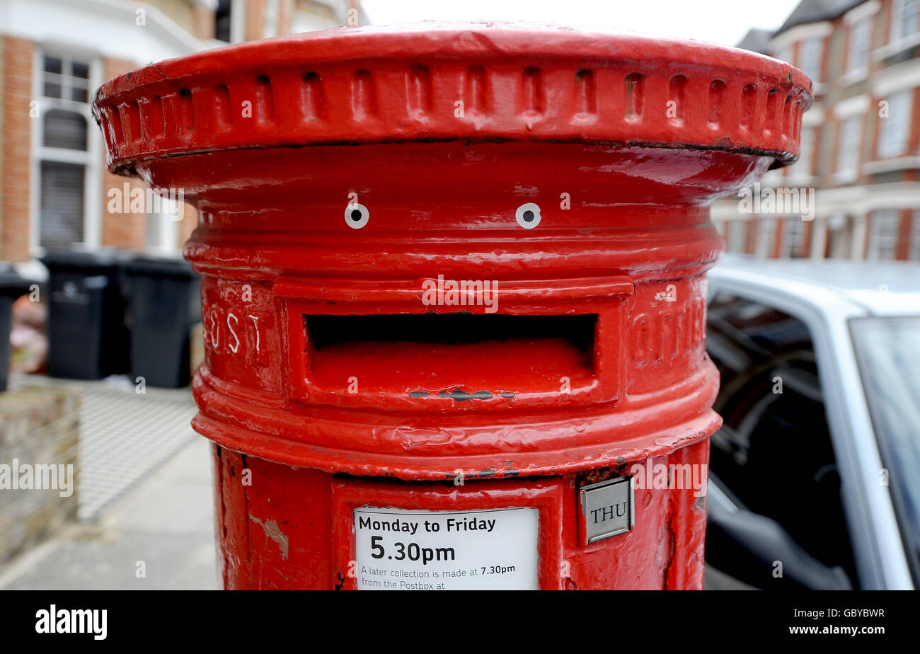 A post box is seen decorated with two stickers which gives the ...
