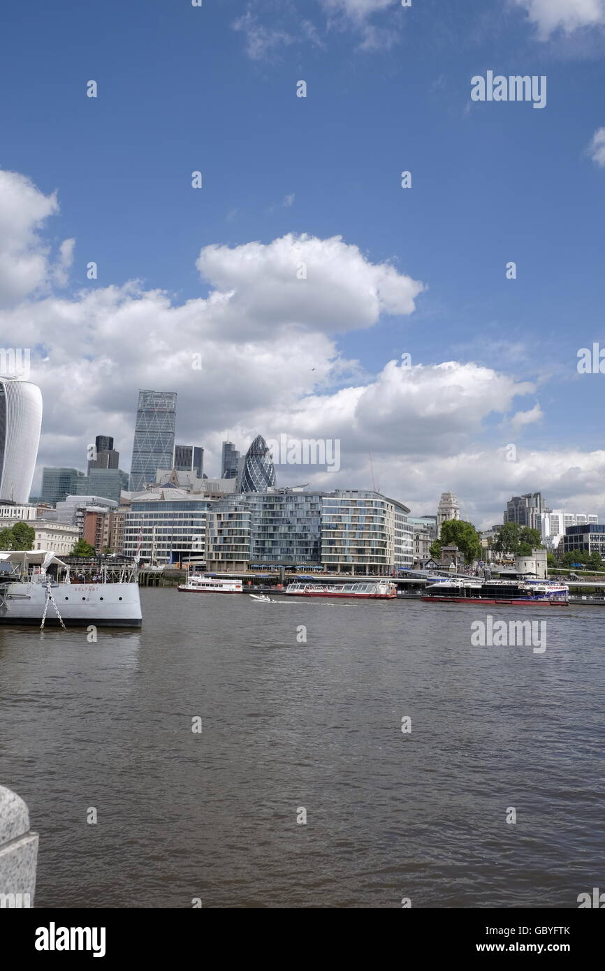 A view across the Thames River with HMS Belfast in the foreground  with 'The Walkie Talkie' 'Cheese grater' 'Gherkin' on Skyline of the City of London Stock Photo