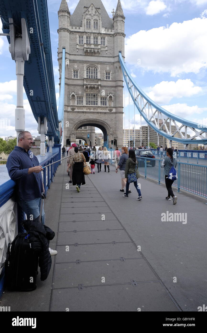 Tourist walk along the walkway on Tower Bridge in the City of London a  London landmark Stock Photo - Alamy