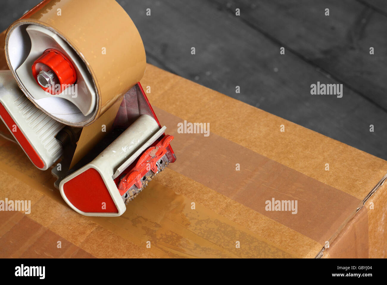 Taping box with a tape dispenser Stock Photo Alamy