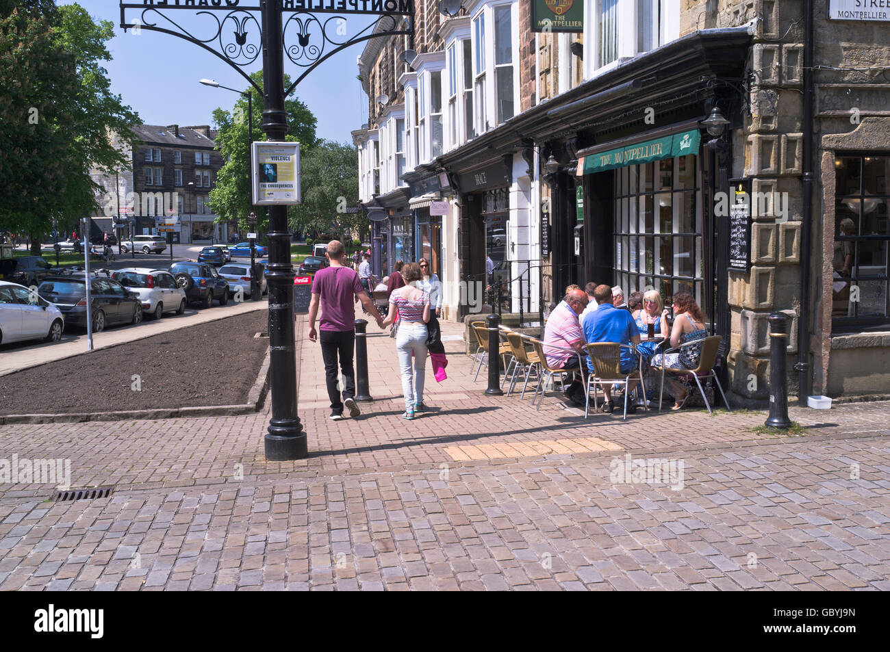 dh  HARROGATE NORTH YORKSHIRE People sitting outside street cafe drinking in sunshine montpellier summer uk streets outdoor dining outdoors Stock Photo