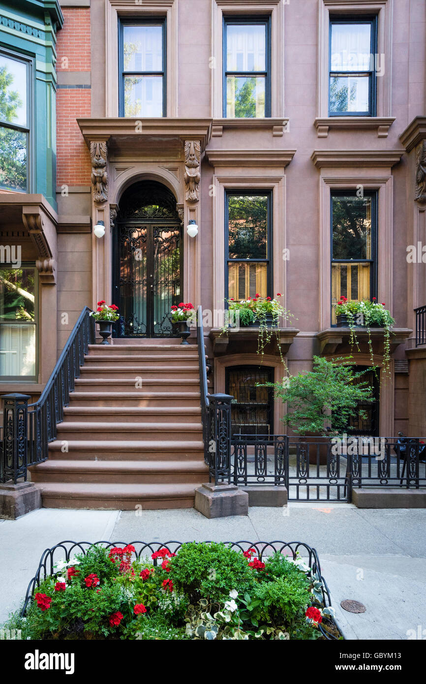 Attractive brownstone residential building decorated with flowers in affluent Brooklyn Heights neighborhood of New York Stock Photo