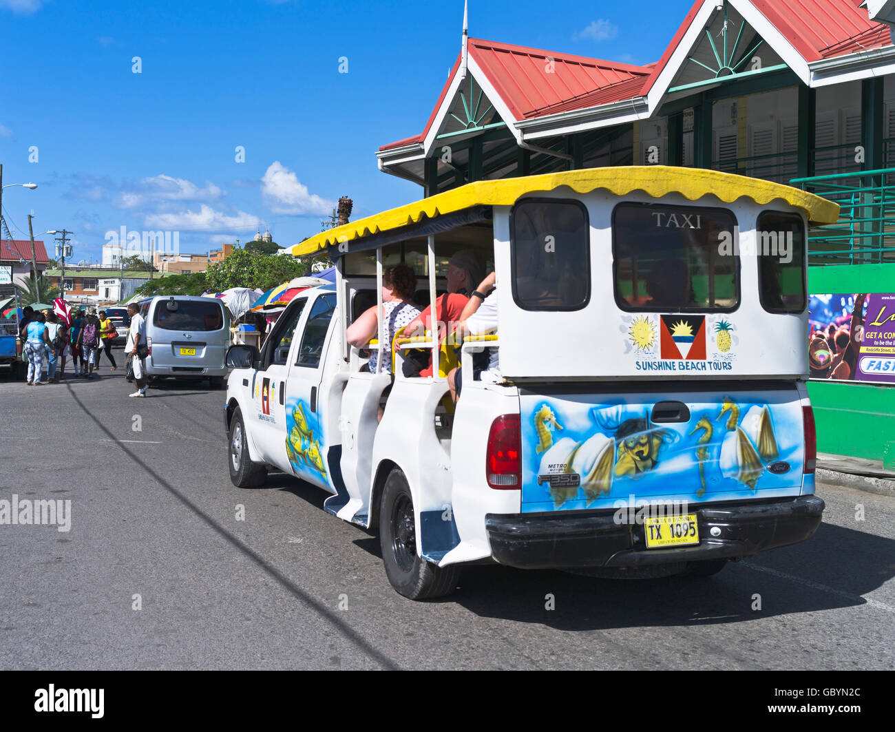dh St Johns ANTIGUA CARIBBEAN Saint Johns street tourists with tourist taxi vacation Stock Photo