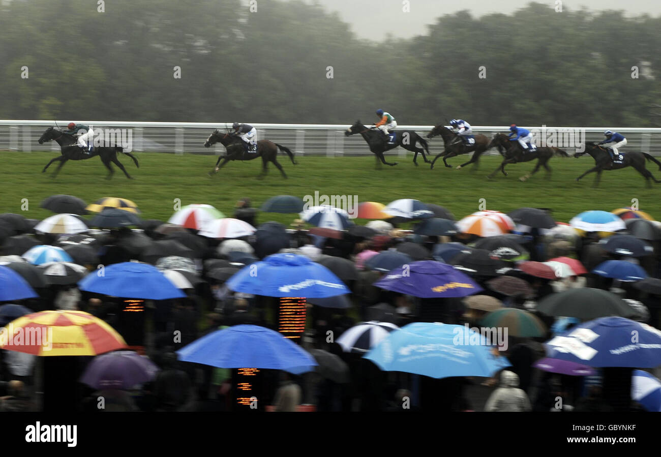 Eastern Aria ridden by Greg Fairley goes clear as the mist and rain falls to win The bluesquarepoker.com Stakes during the Glorious Goodwood Festival at Goodwood racecourse, Chichester. Stock Photo