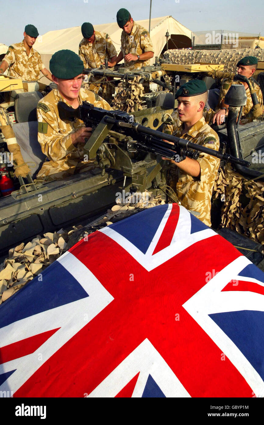 Craig Jones, 18, from Cardiff, with Graham Lusty, 21, marines based at Shaibah Logistical Base with 40 Commando move a rifle on their jeep as others get prepared to move out to Camp Dogwood, 20 miles west of Baghdad. The 40 Commando Royal Marines is part of the Black Watch battle group, which will be operating in the area where the US 24 Marine Expeditionary Unit has been deployed. Stock Photo
