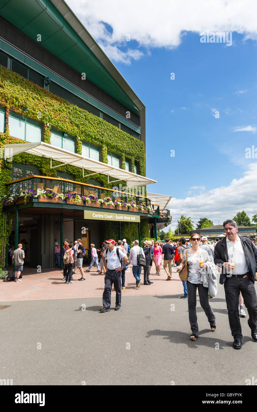 Visitors walk around the grounds and Centre Court South West side on a sunny day during the Wimbledon 2016 tennis championships Stock Photo