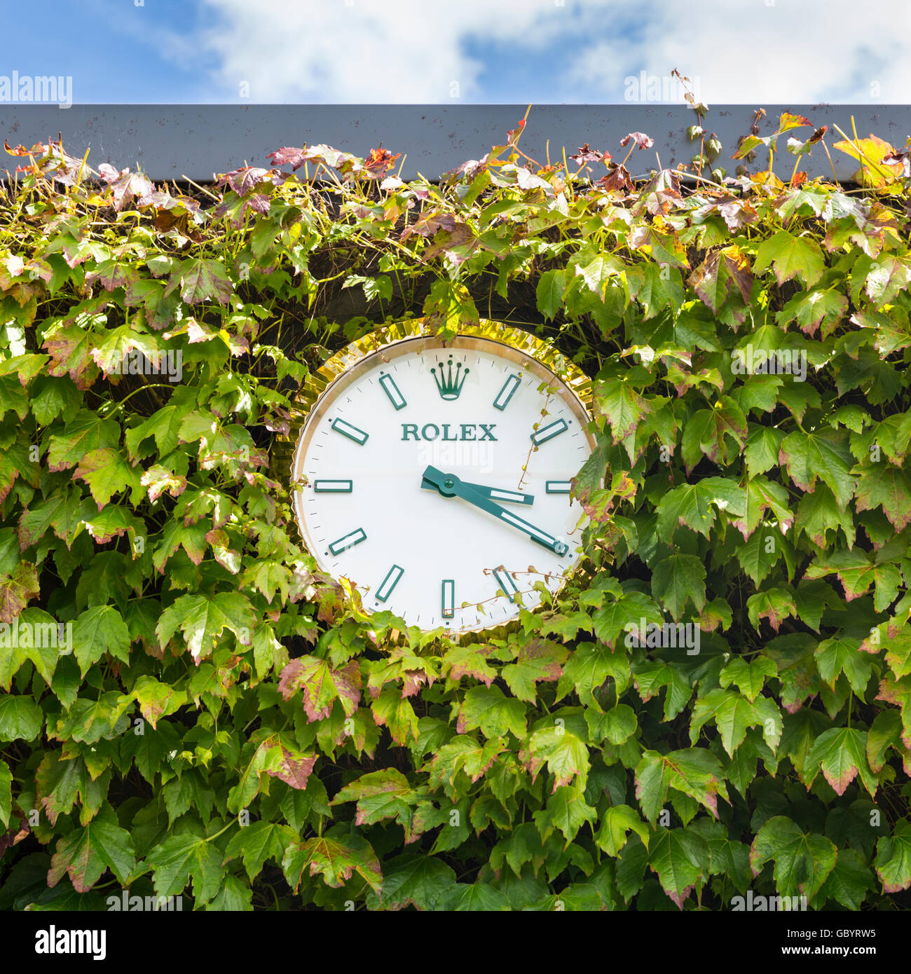 Rolex wall clock surrounded by ivy at the All England Lawn Tennis Club during Wimbledon 2016 Stock Photo