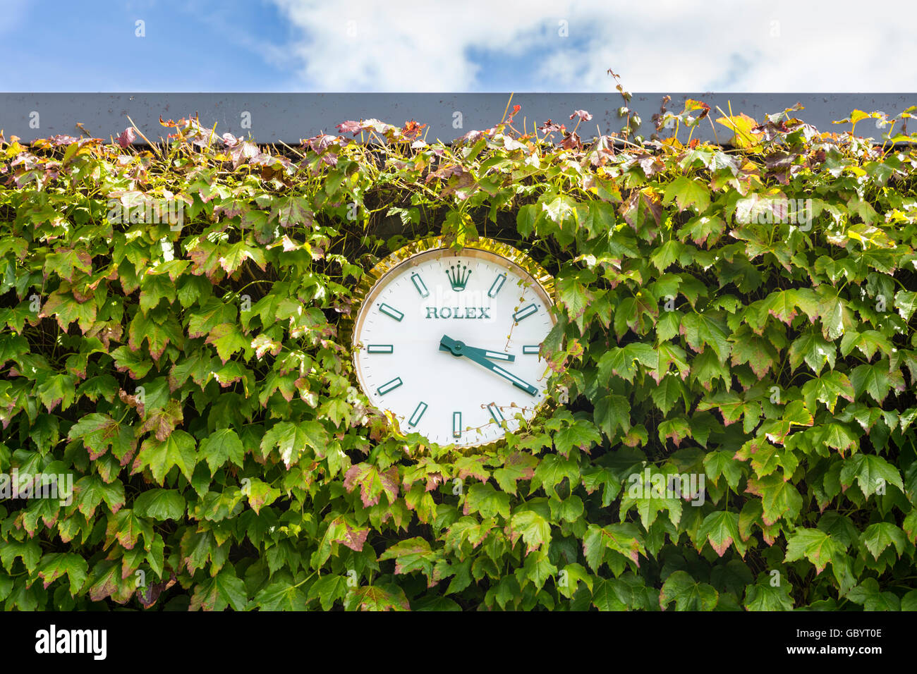 Rolex wall clock surrounded by ivy at the All England Lawn Tennis Club during Wimbledon 2016 Stock Photo