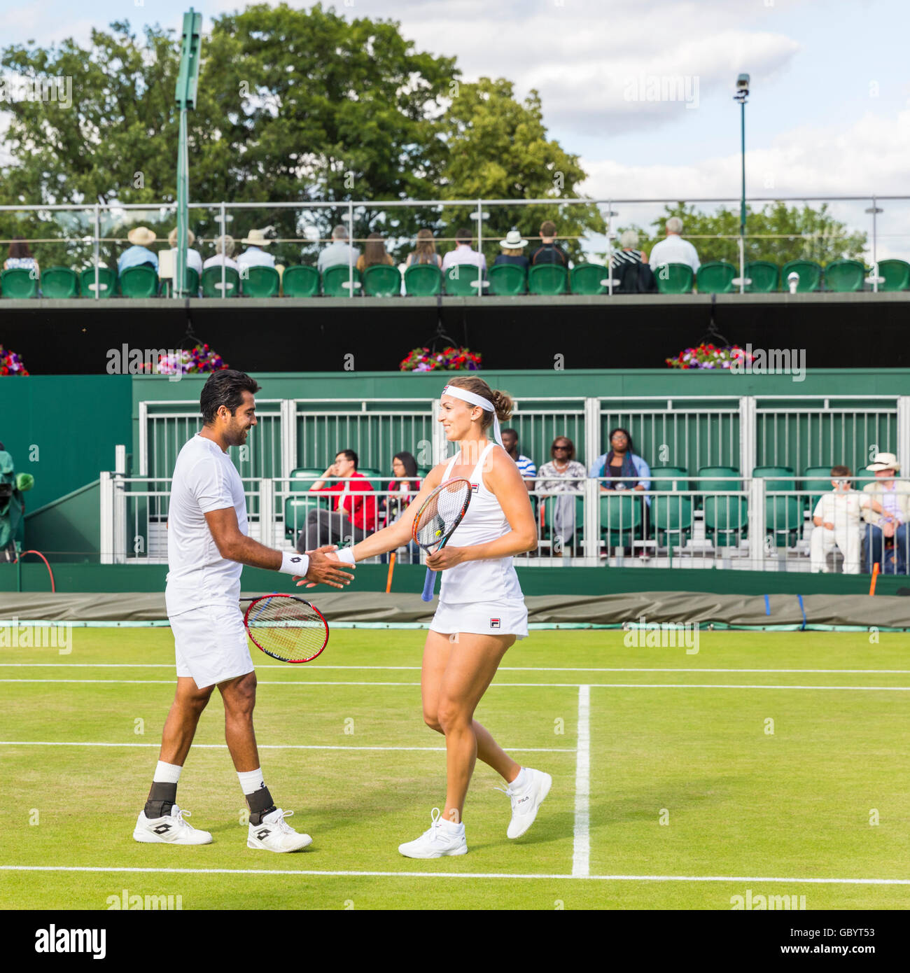 Mixed doubles players Aisam-ul-Haq Qureshi and Yaroslava Shvedova shake hands at the Wimbledon Tennis Championships 2016 Stock Photo